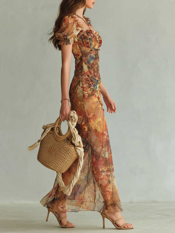 Vibrant orange floral maxi dress for women with elegant puff sleeves, sweetheart neck, and flattering ruched formal style.