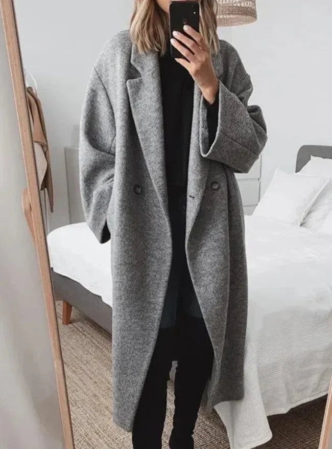 Elegant women's oversized button-down coat in a neutral color, perfect for winter and fall fashion.