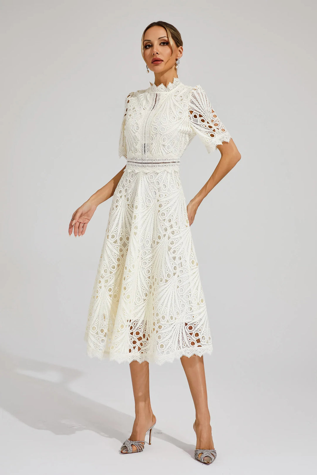 Detail of the neckline on an elegant pink lace midi dress, featuring intricate lace work