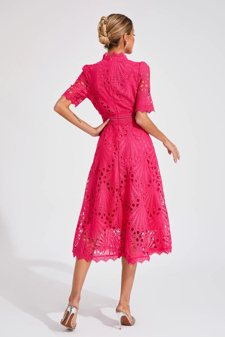 Side profile of a model in a stunning white lace midi dress, showcasing its chic cut