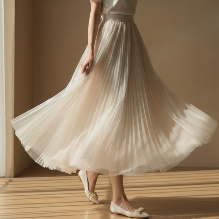 Chic women's flowy pleated A-line skirt. Elegant and versatile for spring/summer fashion, from casual to formal.