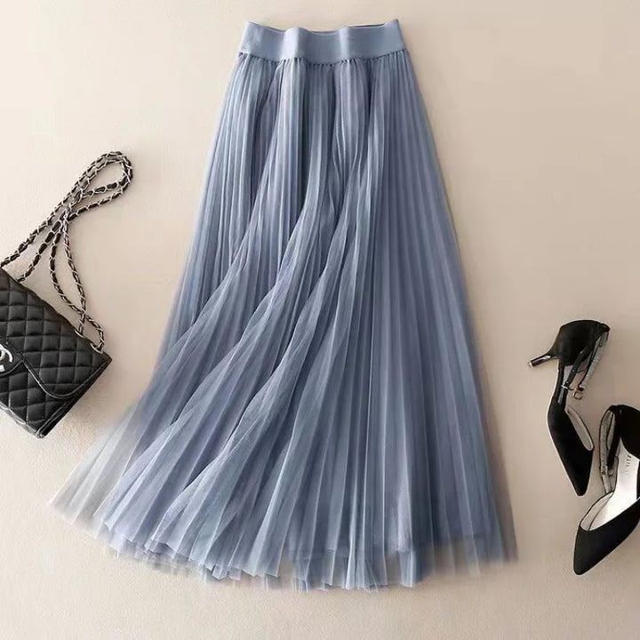 Women's elegant high-waist pleated flowy midi skirt in motion. Perfect for chic spring fashion and effortless style.