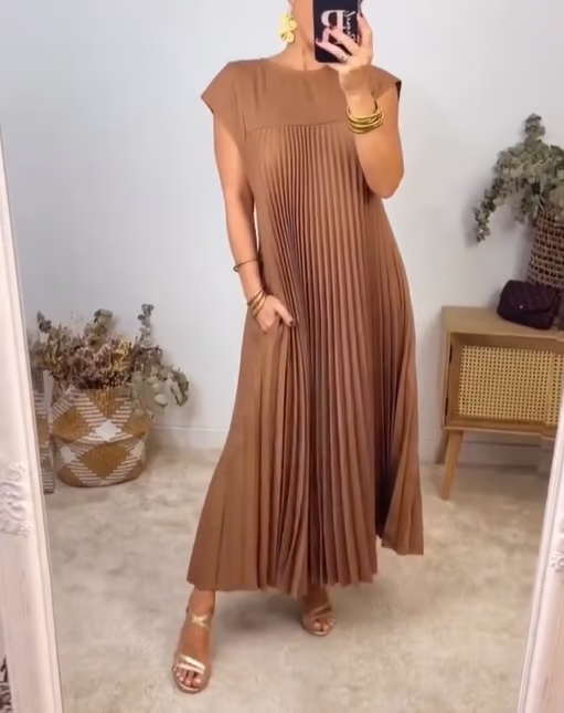 Beautiful women's pleated maxi dress, designed with extended cap sleeves & an empire waist cut.