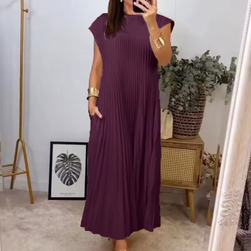Summer-ready women's pleated maxi dress, featuring extended cap sleeves & a relaxed empire waist design.