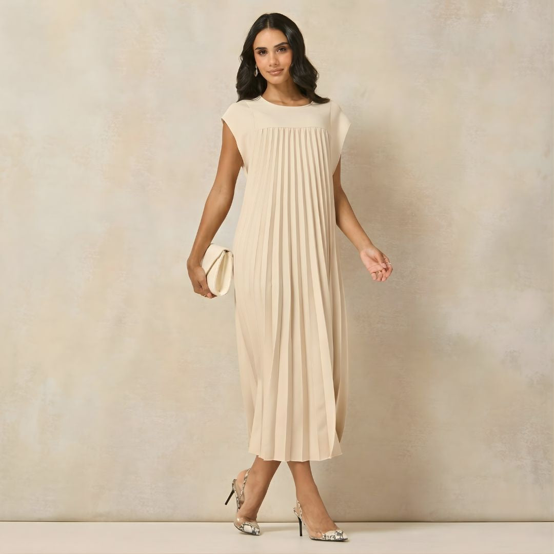Long pleated women's dress with graceful cap sleeves & a relaxed empire waist, ideal for events.