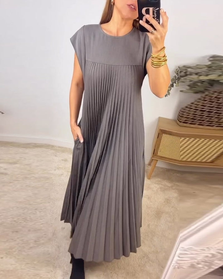 Feminine pleated maxi dress for women, with elegant cap sleeves and a flattering empire waist.