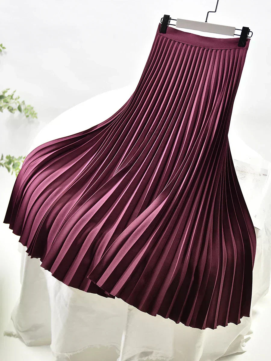 A collection of women's pleated maxi skirts in various colors, essential for spring fashion versatility