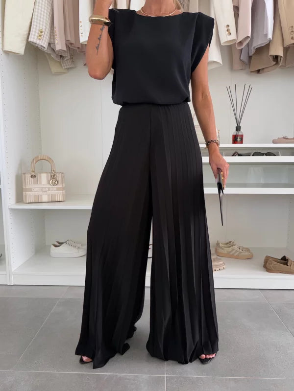 Close-up of women's pleated trousers and top set fabric texture, showcasing comfort & style.