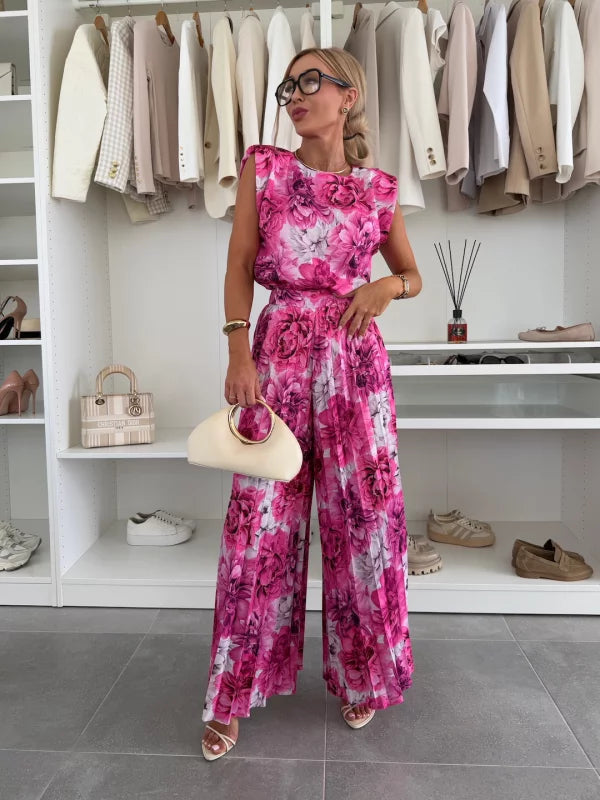 Back view of women's pleated trousers and top set, emphasizing the flow and elegance of the design.