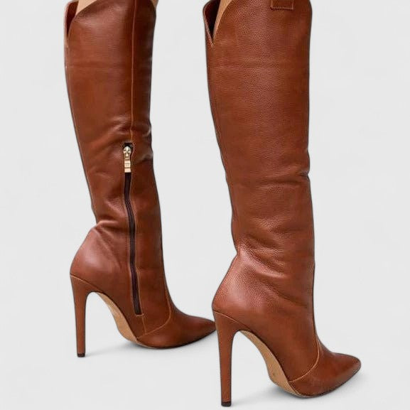 Close-up of a pointed toe and kitten heel on a women's elegant knee-high fashion boot