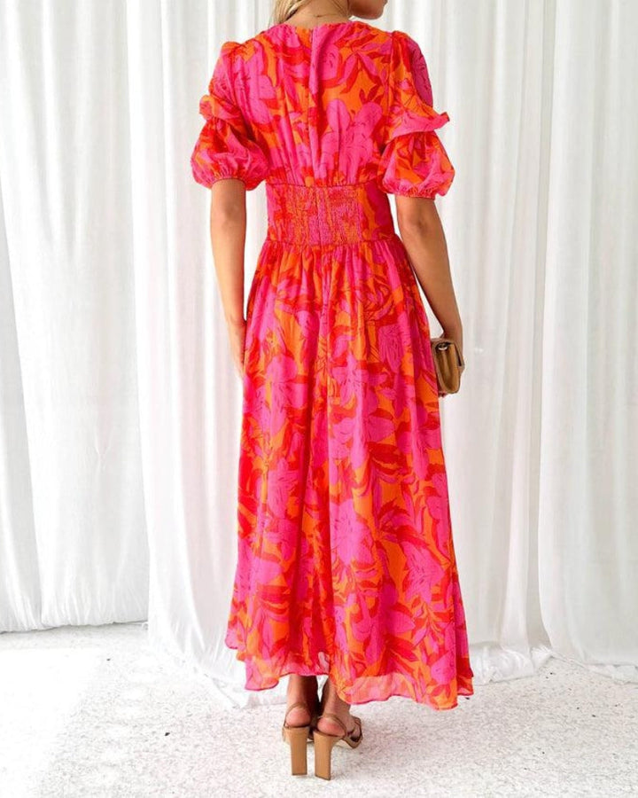 Chic women's printed maxi dress featuring comfortable puffed sleeves & a stylish V-neck. Versatile summer wear.