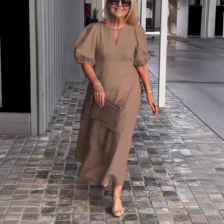 Sophisticated women's puff-sleeve midi dress. Perfect spring outfit or elegant summer style.