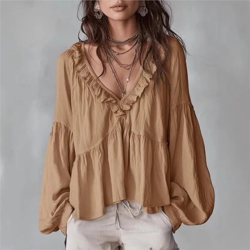 Elegant women's ruffle blouse with puff sleeves & V-neck, flowy fabric perfect for stylish casual wear.