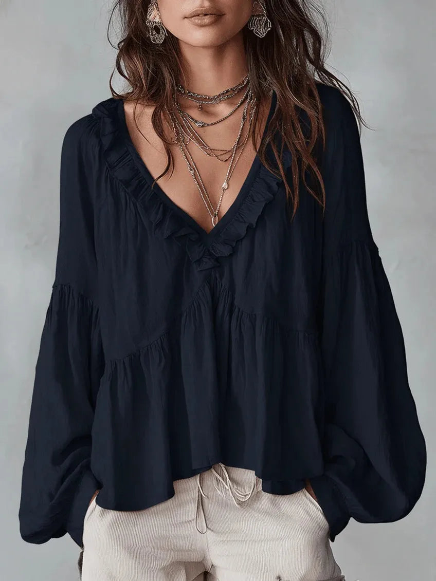Flowy women's blouse with stylish ruffles & comfortable puff sleeves. V-neck design for an effortlessly elegant look.
