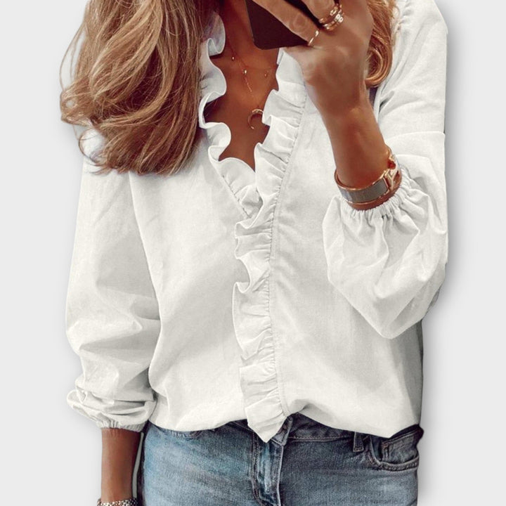 Elegant women's ruffled summer blouse in a soft fabric, perfect for sophisticated style or office wear. Lightweight and chic.