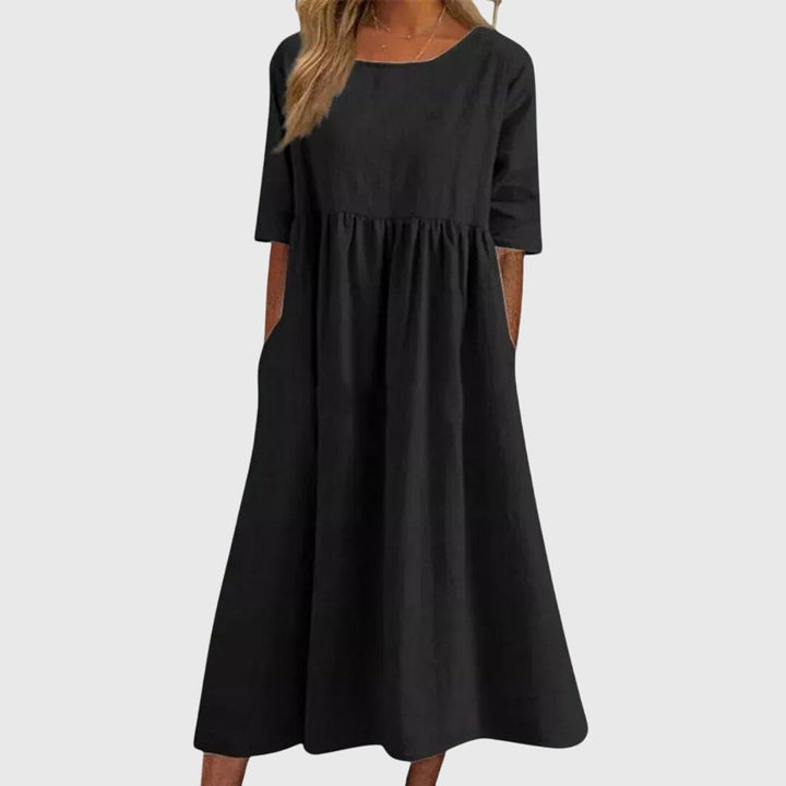 Classic women's short-sleeve dress. Elegant design adapts from casual daywear to chic party attire. Flattering for all.
