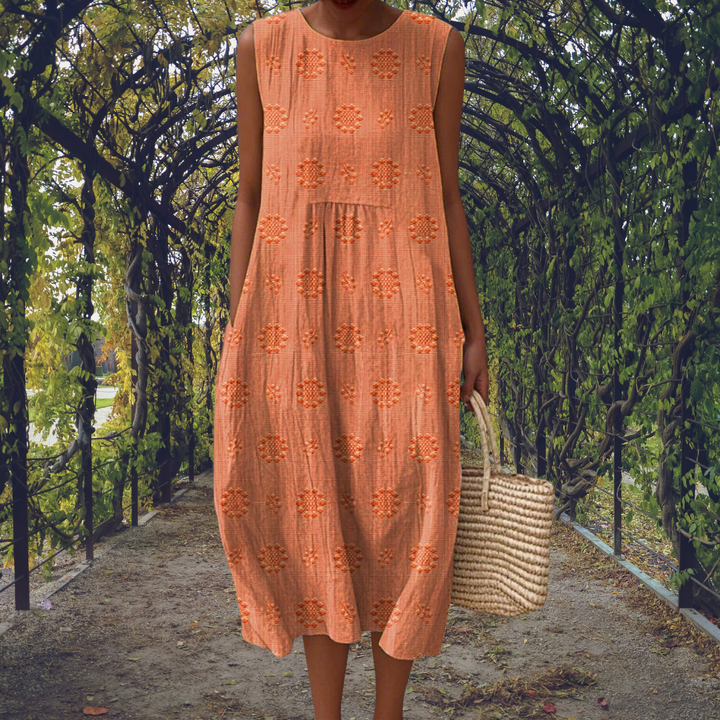 Model wears an elegant women's sleeveless midi dress, flowy & textured, perfect for summer casual outings. Round neck.