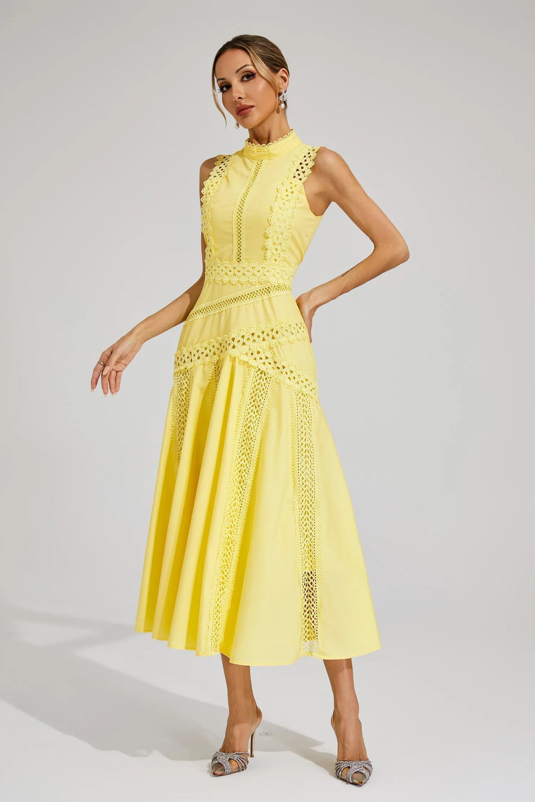 Woman confidently wearing an elegant sleeveless lace panel midi dress, ideal for summer or evening events.