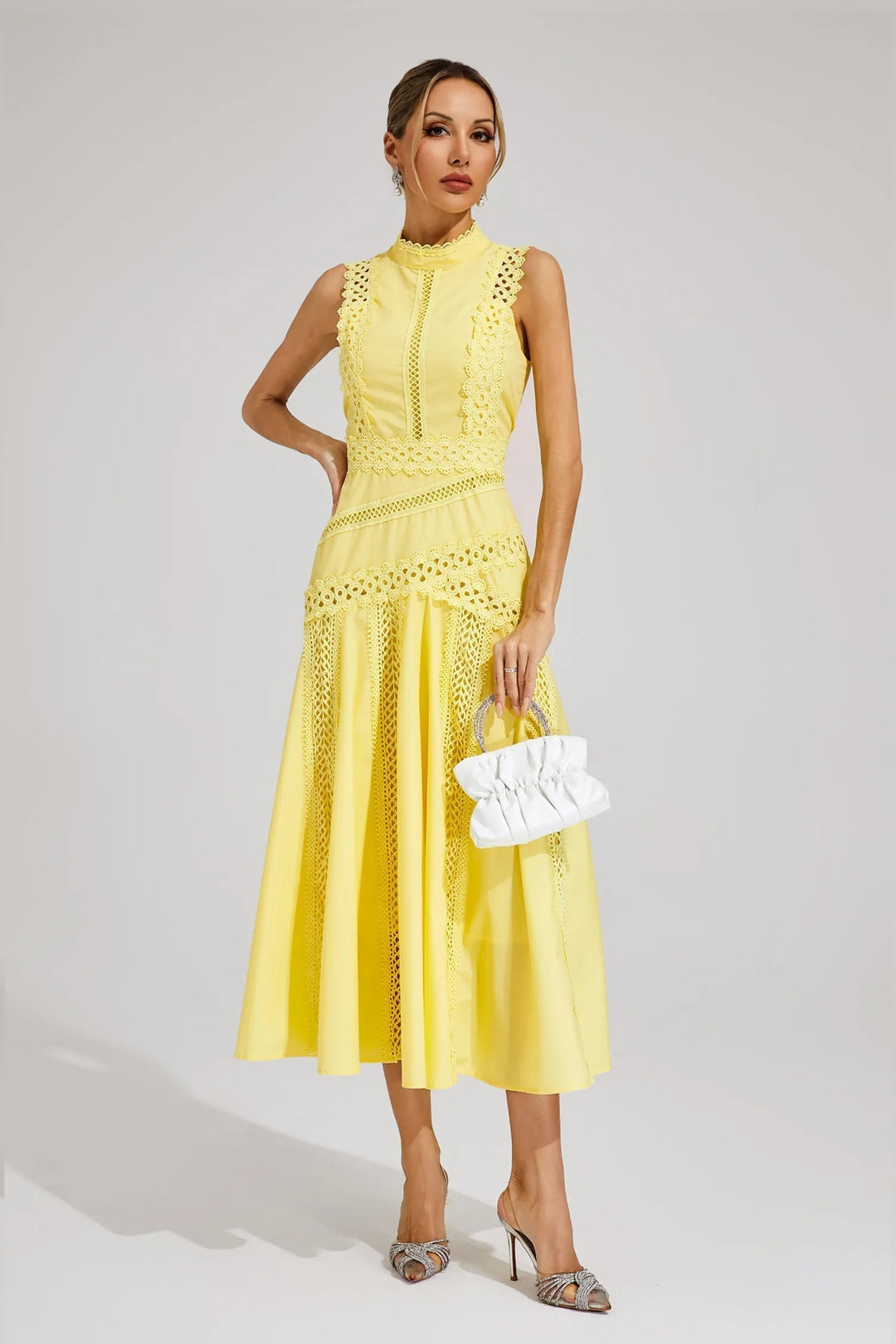 Close-up of the exquisite lace panel detail on an elegant women's sleeveless midi dress, ideal for parties.