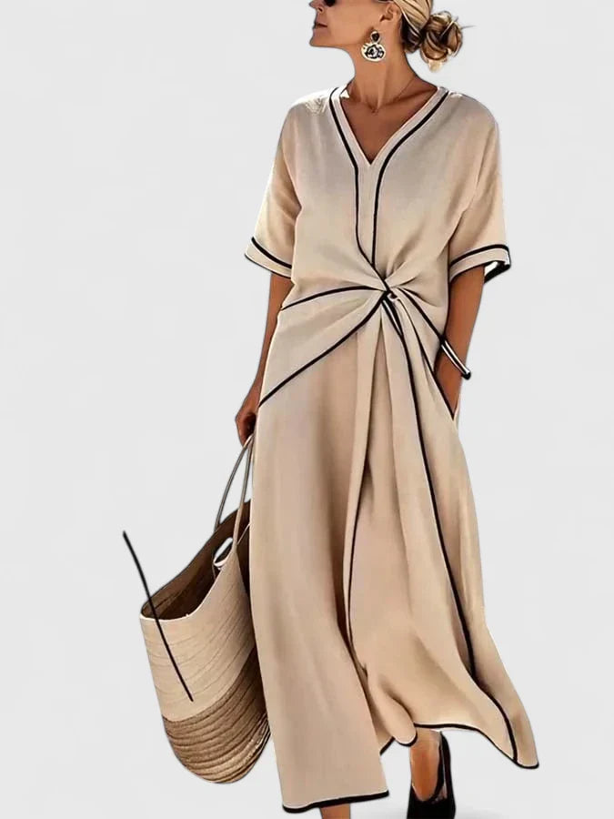 Elegant women's striped midi dress for summer. Comfortable short sleeve design, perfect for casual or vacation wear.