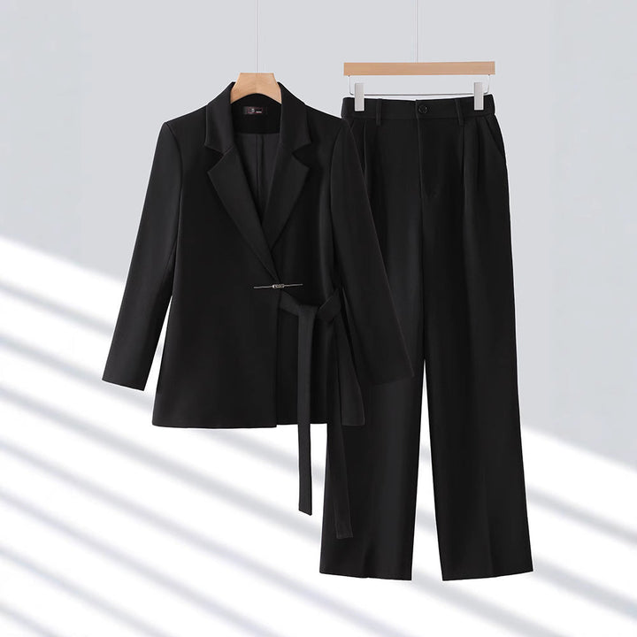 Two-piece women's trouser suit featuring a sophisticated long tailored blazer, business attire