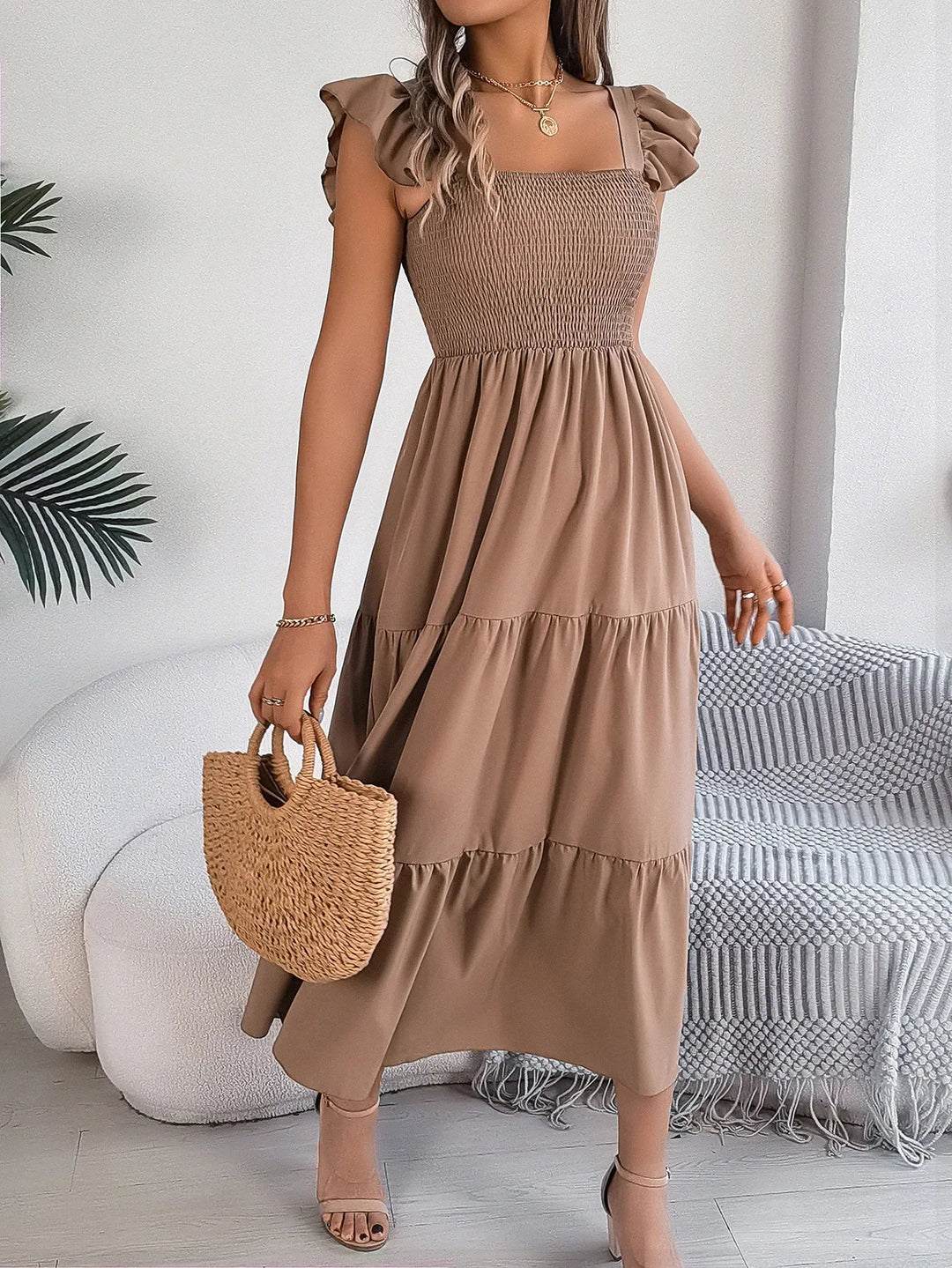 Chic women's tiered midi dress with smocked bodice & ruffled sleeves, ideal for casual elegant style.