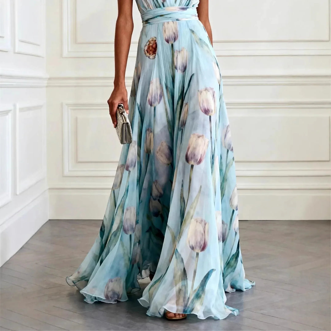 Close-up of vibrant tulip floral print on a flowing women's wedding guest midi dress, elegant design.