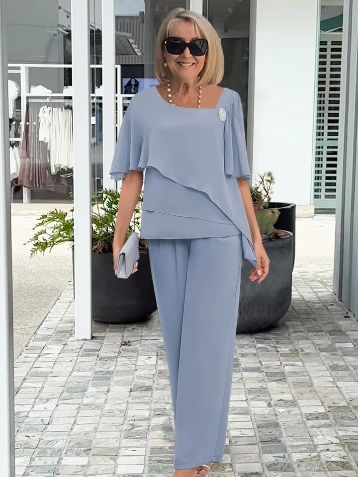 Navy blue formal women's cape top and matching trousers, a stylish two-piece outfit for special occasions.