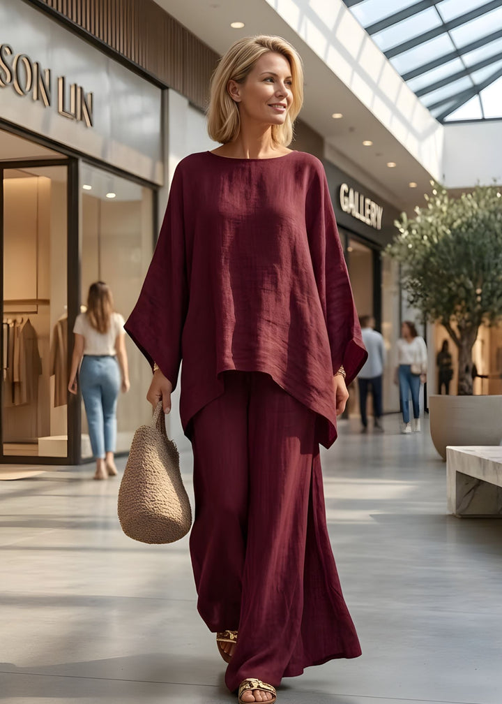 Stylish women's cape top and wide leg pants set, a sophisticated and comfortable monochromatic outfit for vacation.