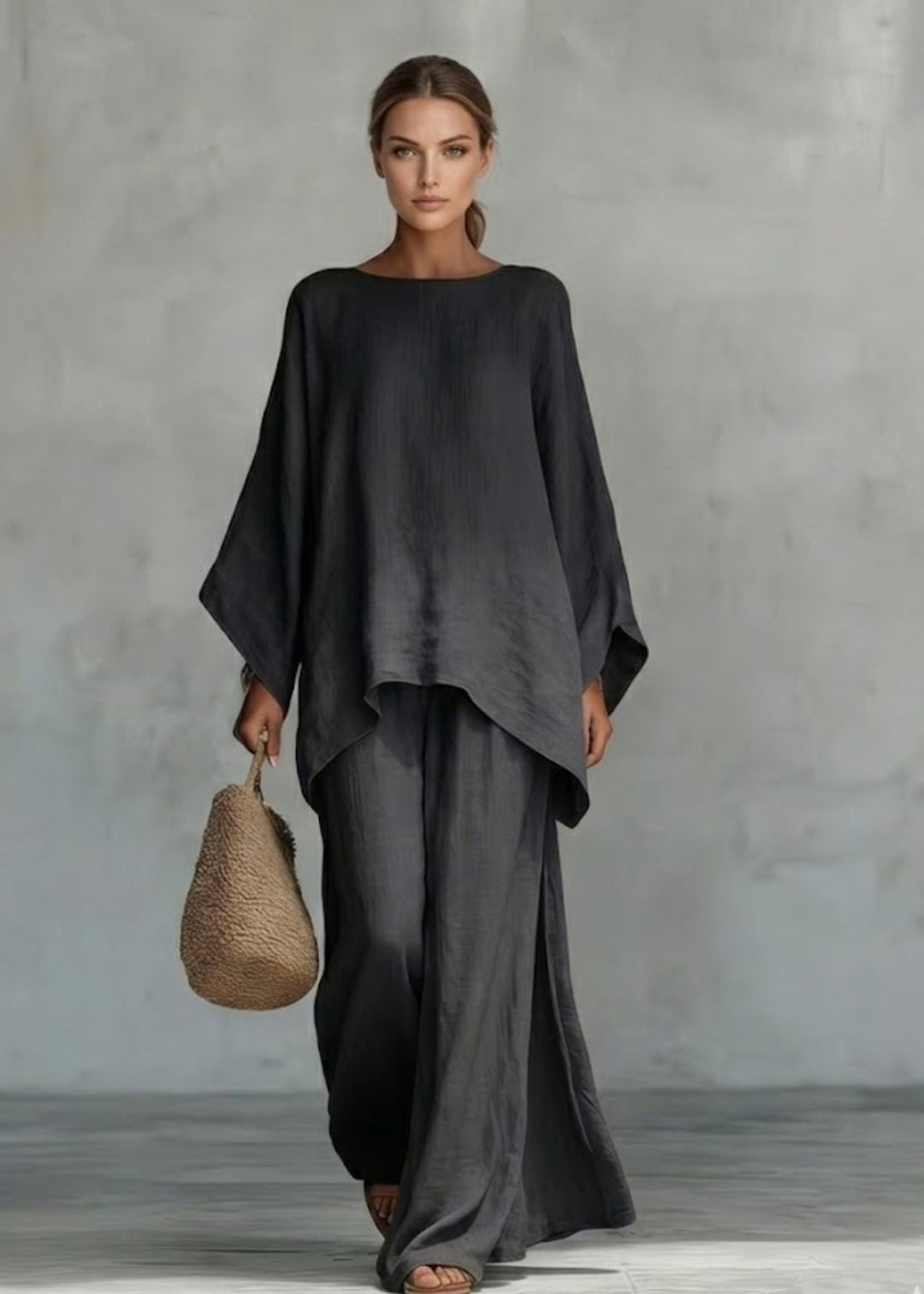 Monochromatic women's two-piece outfit with an elegant cape top and comfortable wide-leg pants for summer elegance.