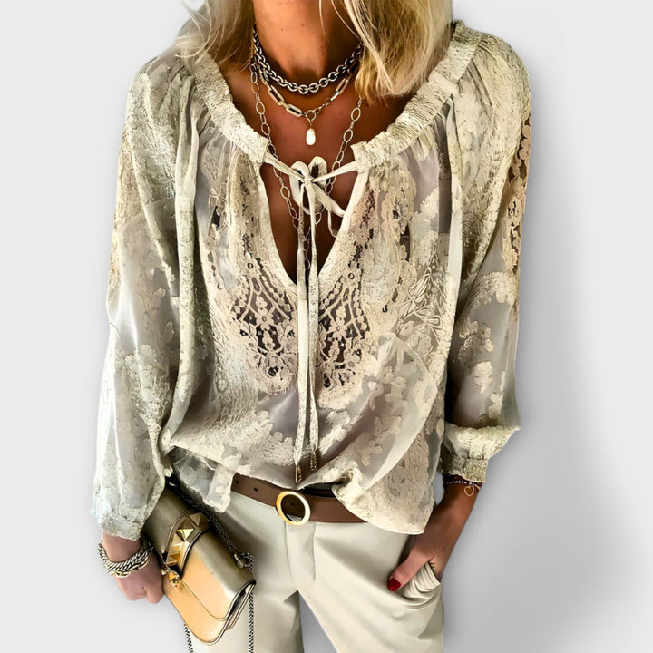 Chic black women's V-neck lace top with long sleeves, a fashion-forward choice for elegant evening or casual outfits.