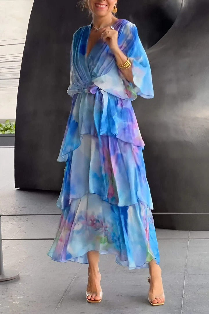 Woman's elegant flowy maxi dress featuring a beautiful watercolor print, ideal for evening & summer parties.