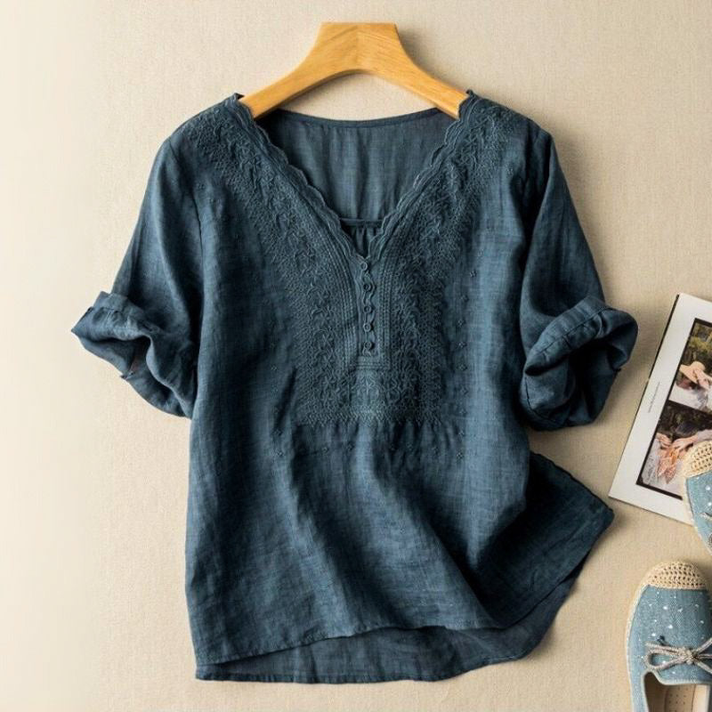Feminine women's blouse with intricate colorful embroidery and a stylish V-neck. Chic summer top with relaxed fit.