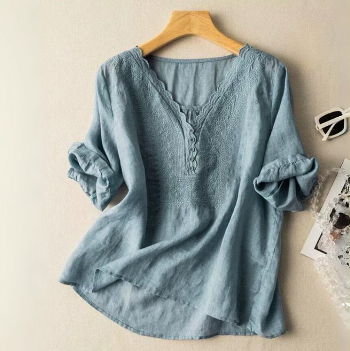 Chic women's embroidered blouse with vibrant floral patterns, V-neck, and comfortable relaxed fit for spring.