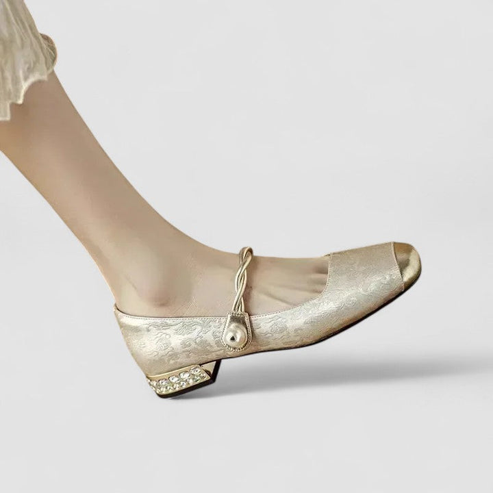 Pair of women's pearl strap block heels in a vibrant color, artistic shot