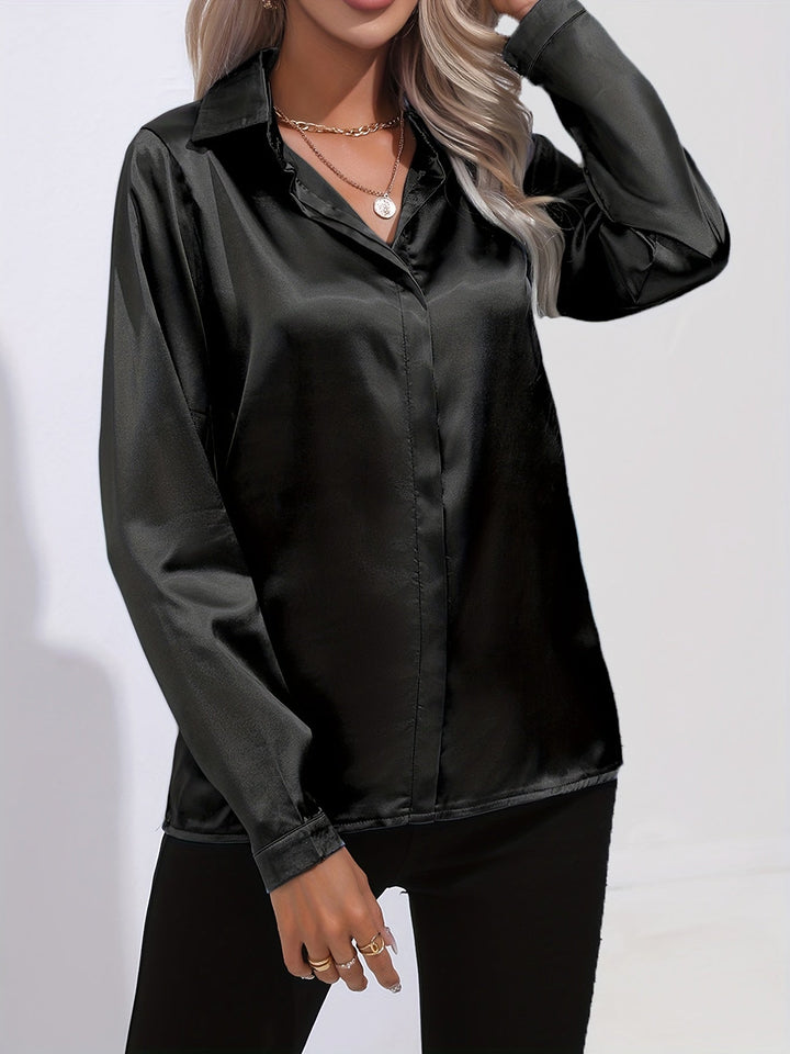 Model wearing a white satin long sleeve button down blouse, styled for a professional look.