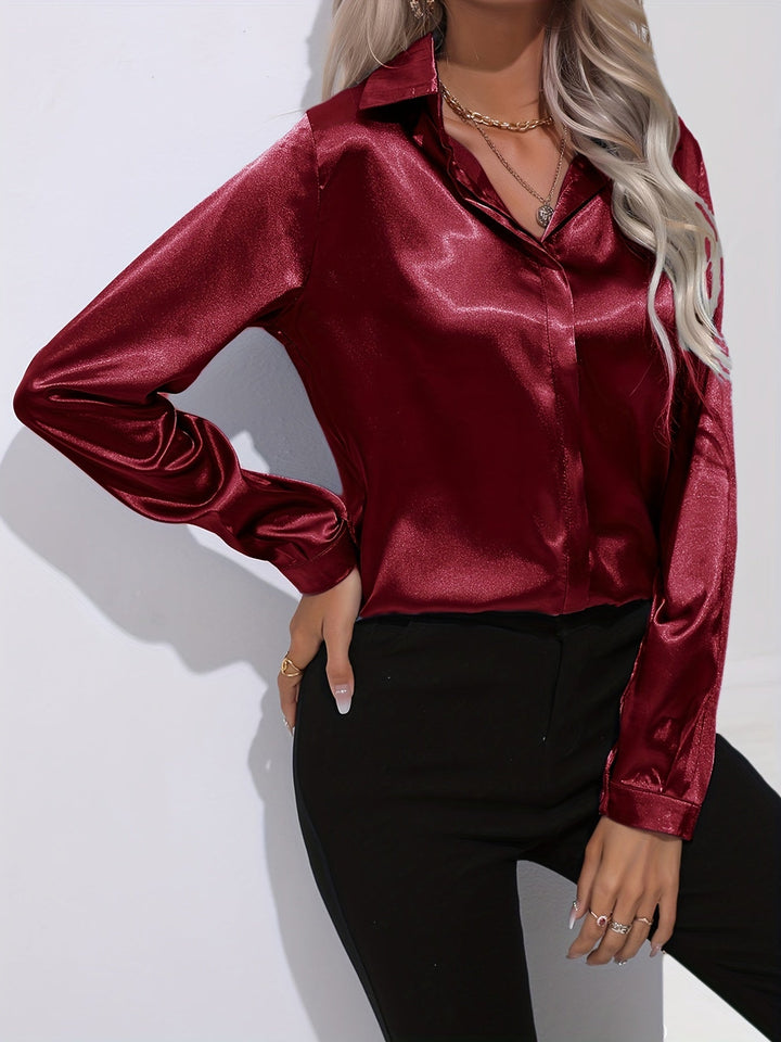 Stylish women's silver satin long sleeve button down blouse, perfect for a modern, chic outfit.