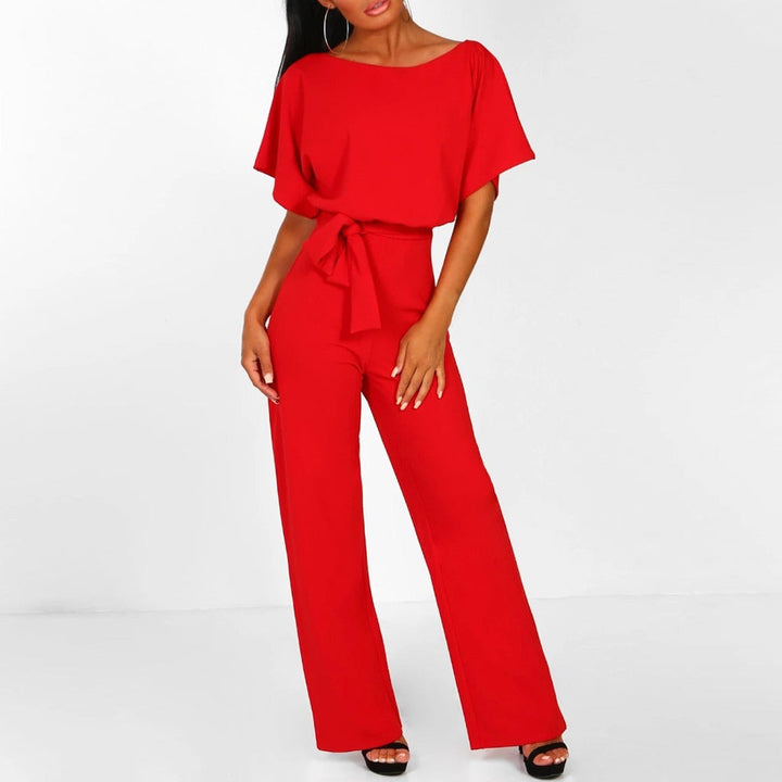 Full-length shot of an elegant women's wide leg belted jumpsuit. A versatile boat neck design for chic casual or dressy wear.