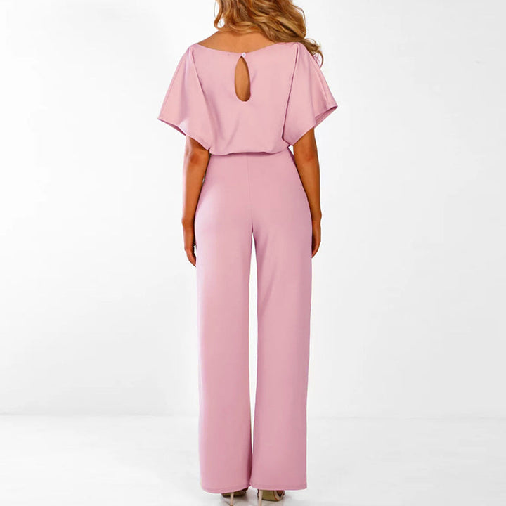 Woman modeling an elegant wide leg belted jumpsuit. Ideal for versatile, comfortable casual wear in spring/summer fashion.