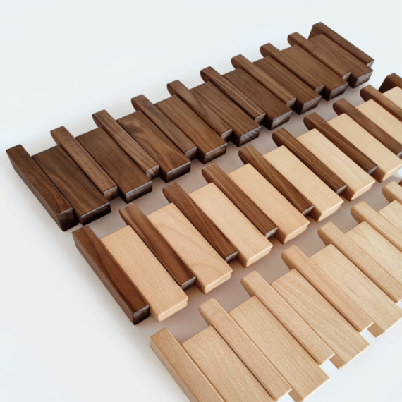 "Elegant wooden coat rack with magnetic hooks, crafted from walnut and beech, offering a sleek, natural aesthetic."