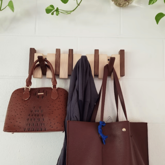 "Elegant wooden coat rack with magnetic hooks, crafted from walnut and beech, offering a sleek, natural aesthetic."