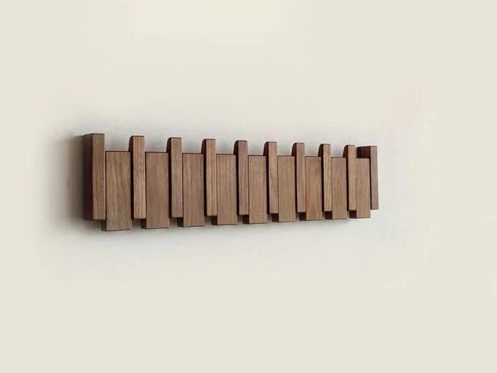 Entryway wooden coat rack, piano key design. Space-saving wall organizer with wood finish.