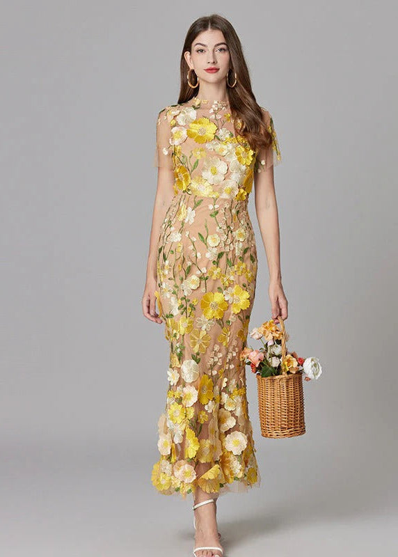Elegant yellow maxi dress with 3D floral appliqué & sheer design, perfect for wedding guests or formal events.