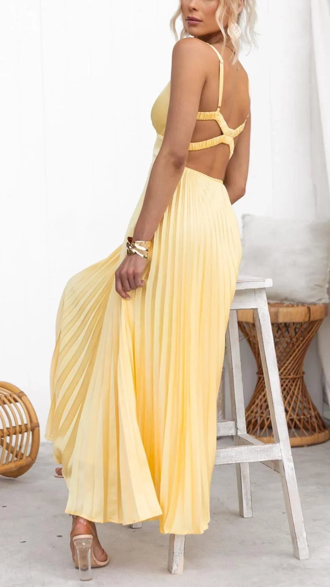 Close-up of the pleats and V-neck detail on a women's yellow elegant maxi dress