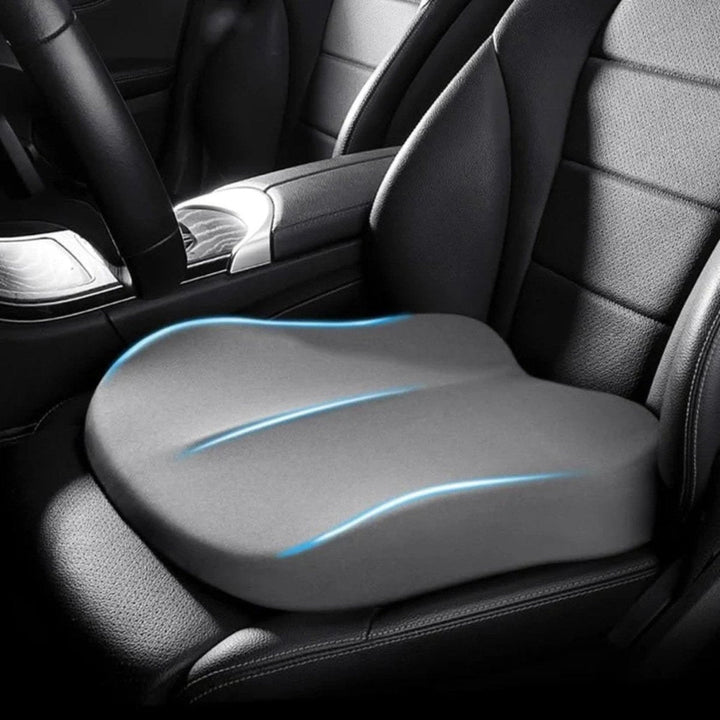 Black ergonomic car seat cushion, a car accessory enhancing driver comfort, posture, and road visibility.