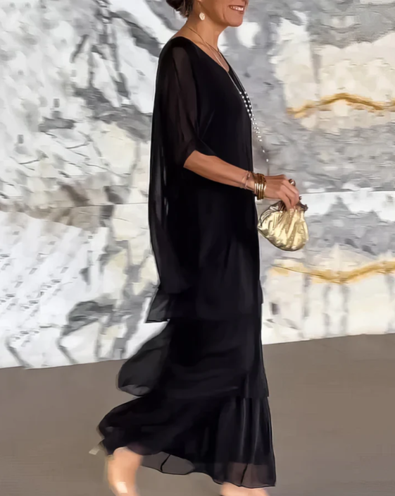 Printed tiered maxi dress for women, featuring a flowing silhouette and elegant long sleeve style.