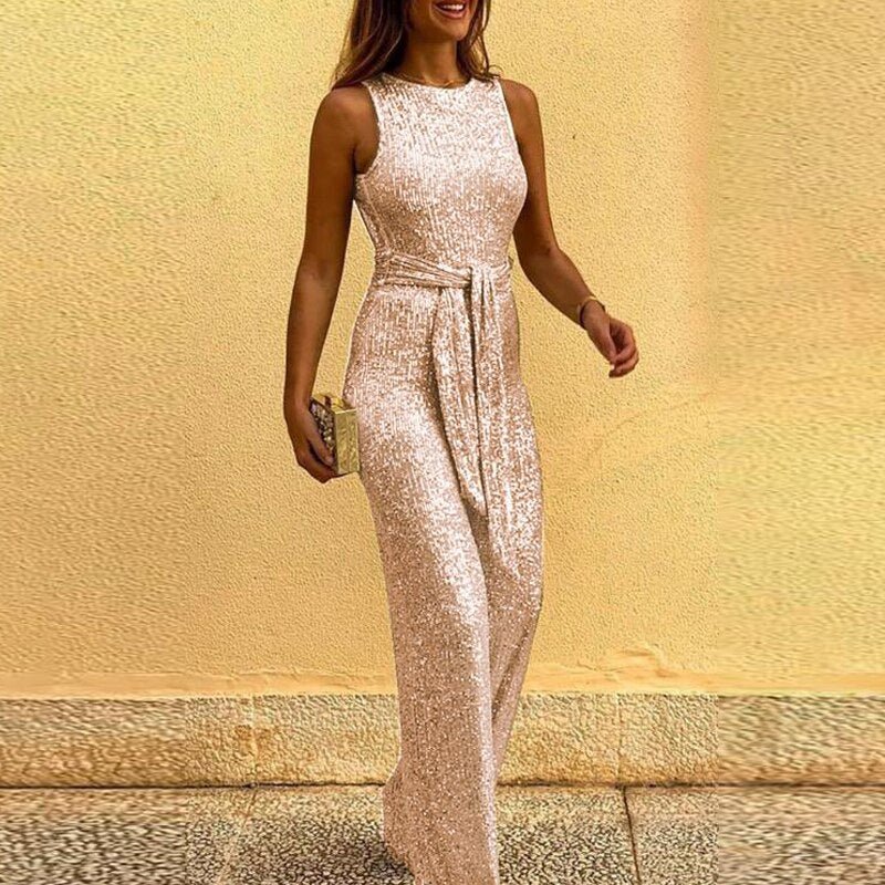 Front view of woman in silver sequin jumpsuit with backless design, perfect for glamorous events.