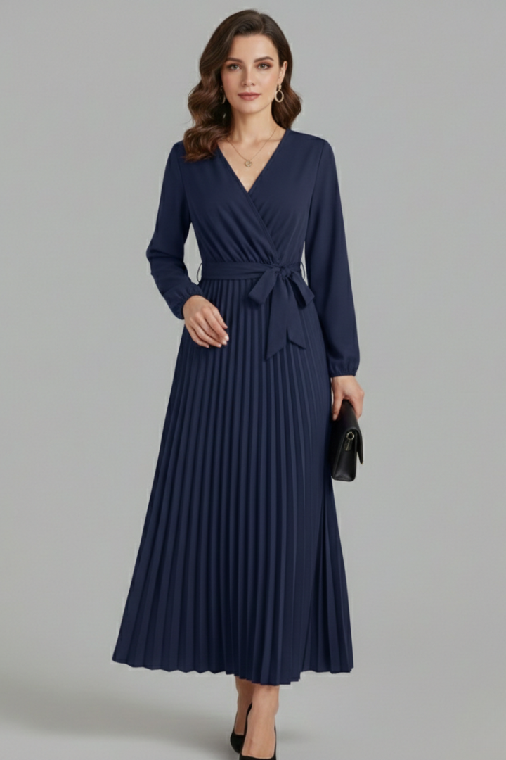 Full length view of a women's versatile V-neck maxi dress with a flowing pleated skirt and an elegant tie waist.