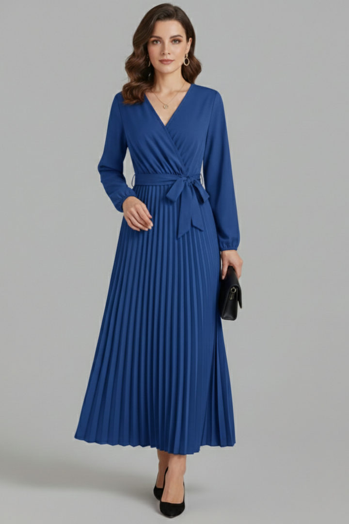 Close-up of the elegant tie waist & flowing pleated skirt on a women's V-neck maxi dress.