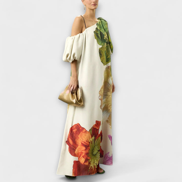 Flowy green floral maxi dress with an elegant asymmetrical neckline, perfect for summer vacations.